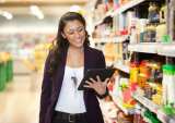 woman with tablet grocery shopping