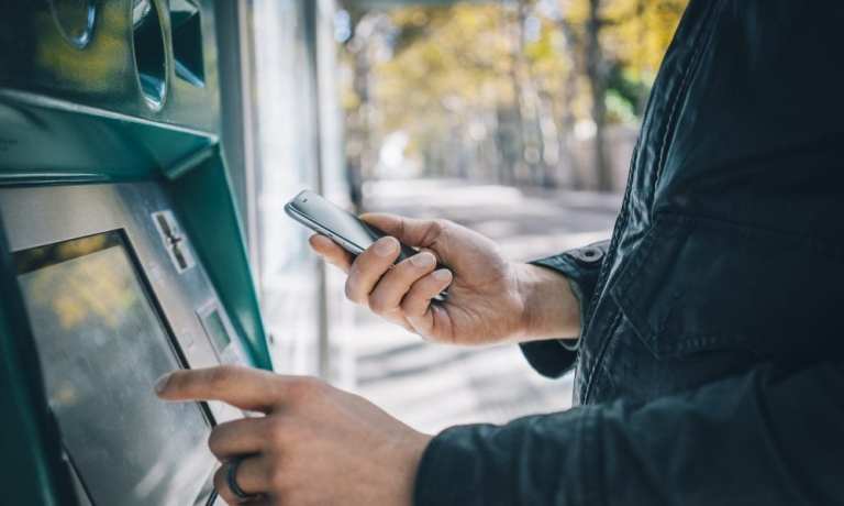 person at ATM