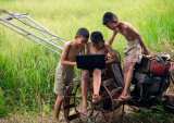 children on farm with laptop