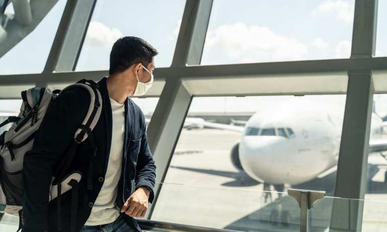 man wearing face mask at airport