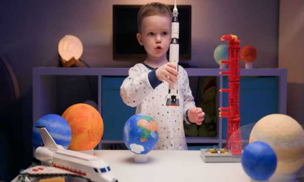 little boy with space toys