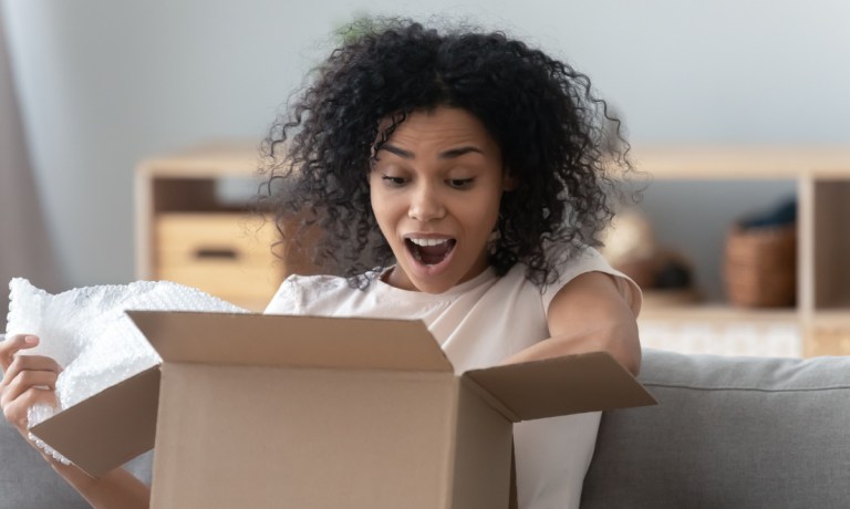 young woman opening suprise box