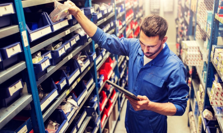 man checking shelves in car parts store