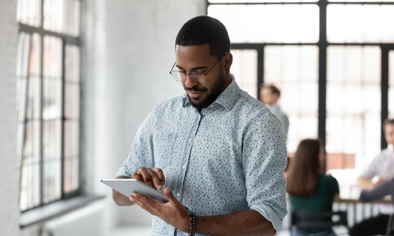 man using banking app on tablet