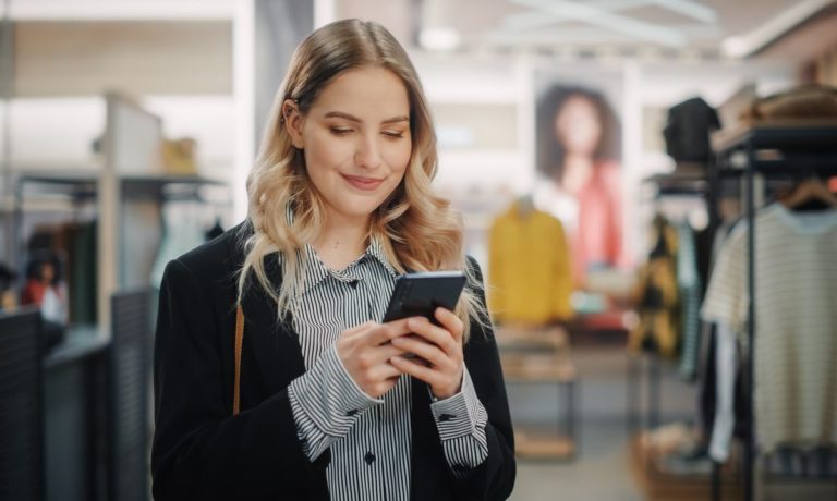 woman texting in store