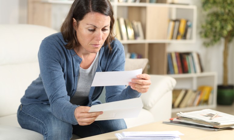 woman looking at bills