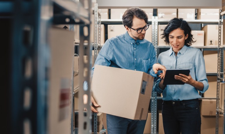 retail managers in stock room with boxes