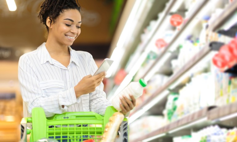 woman using smart phone app in store