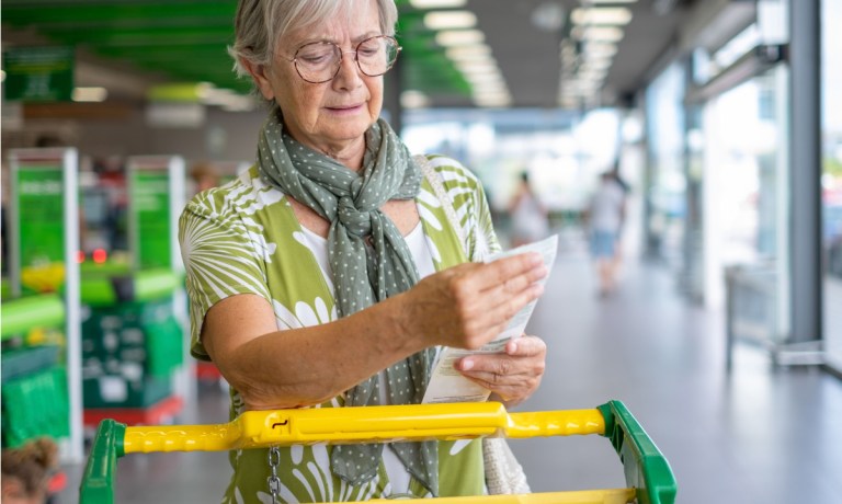 woman checking receipt at grocery store