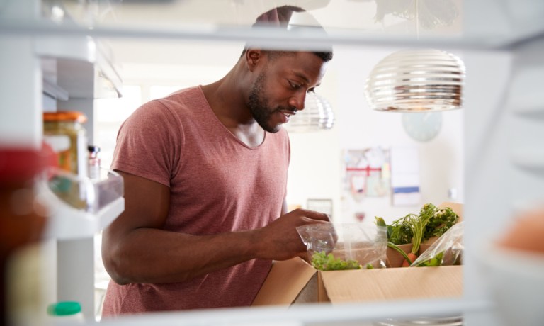 man unpacking meal kit