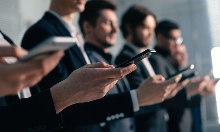 group of people holding smartphones