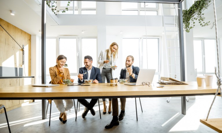 office workers eating on conference room