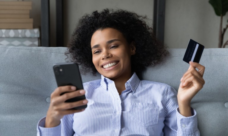 young woman shopping online with phone