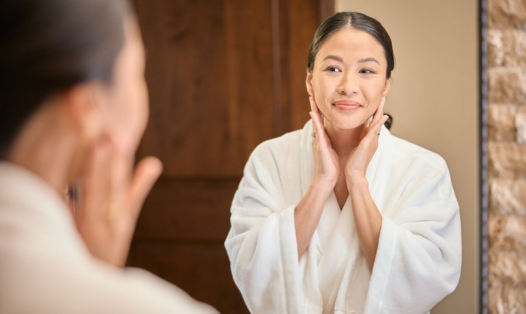 woman looking in mirror