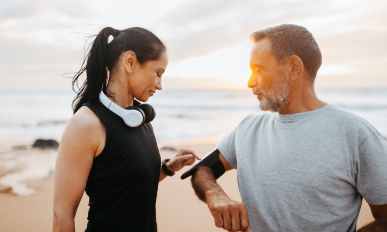 couple running with fitness app