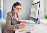 office worker with spreadsheet on computer