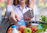 woman paying for groceries with credit card
