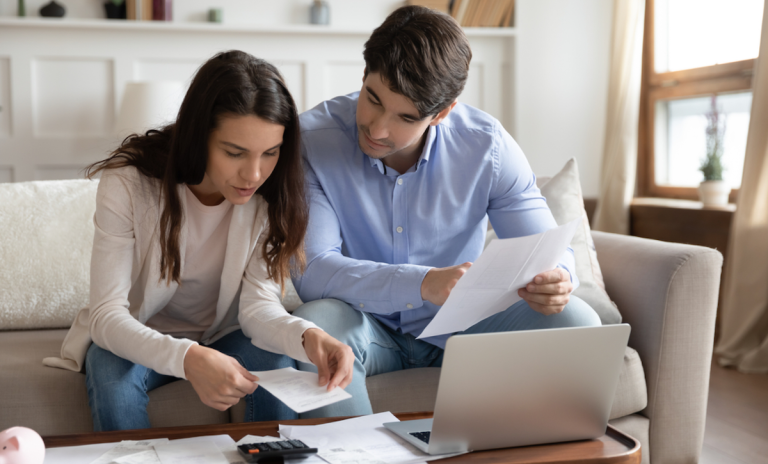 couple reviewing bills, budget