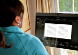 woman reading on Peloton bike