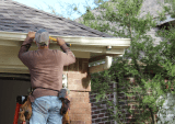 man working on house exterior