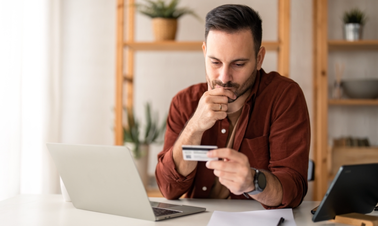 man looking at credit card