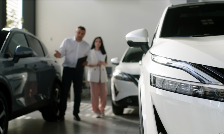 two people in car showroom